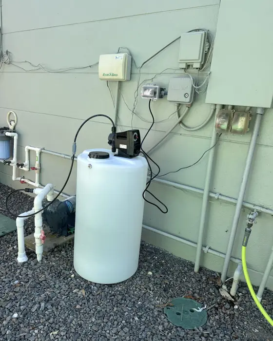 Rust prevention solution tank and injection pump plumbed into an irrigation system