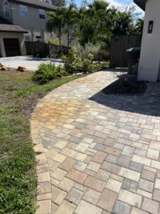 Orange irrigation rust staining along a paver walkway in Florida